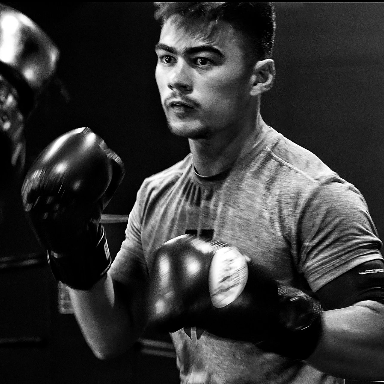 Young man boxing gloves black white portrait
